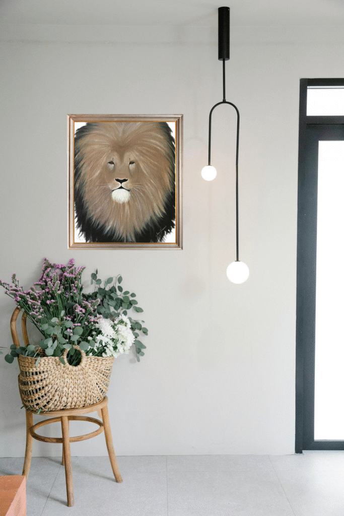 A regal lion rests calmly on golden terrain, exuding strength and grace—perfect for safari or rustic-inspired digital décor.